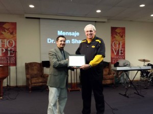 Associational Missionary John Shaull presents a certificate to Pastor Arnaldo Achucarro recognizing Cristo Vive as a constituted church body.