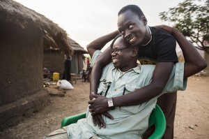 Pastor Tolbert Alochi is embraced by a young man who received help at Faith Baptist Church in Nimule, South Sudan.  IMB photo by JoAnn Bradberry.