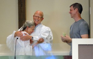 East Boulder Baptist Church Senior Pastor Larry Dramann (center) is embraced by Donna Gail following her baptism at the church. Gail’s friend, Travis Kunckel (right), traveled from Texas with his family to attend the service. Kunckel and his wife, Denise, discipled Gail. NAMB photo by Susan Whitley