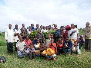 Pastor Alobo (far left) and his congregation at Dzaleka.