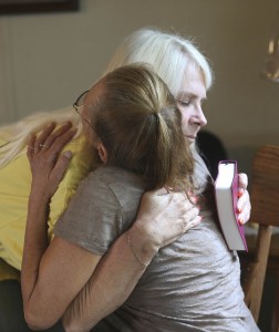Barbara Guidry (left) hugs property owner Patty Wetzel (right) of Twisp, Wash., after giving her a Bible. Guidry, a Southern Baptist Disaster Relief (SBDR) volunteer from LaBelle Baptist Church of Beaumont, Texas, wrote a special message to Wetzel in the Bible, which was also signed by other SBDR volunteers who had cut down fire-damaged trees in her backyard. Volunteers are providing free ash-out and chainsaw work throughout North Central Washington. NAMB photo by Don Seabrook