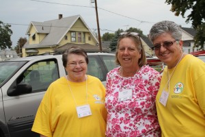 Missionfest volunteers Helen Henley, Mary Allen and Rosann Lafata prayerwalk and invite area residents to Hope of Glory Church.