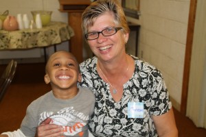 Teresa Bailey, WMU director for the Northwest Ohio Baptist Association, meets a new little friend during Missionsfest.