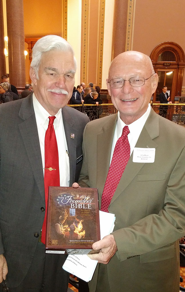 Jerry Mease, from New Bridge Church in Winterset,  presenting a Bible to State Representative Stan Gustafson.