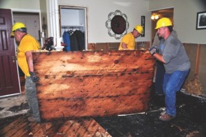 James King (left), Richard Brown and David Matlock, disaster relief volunteers with the Baptist General Convention of Oklahoma, remove floorboards and sheetrock from one of many flooded homes throughout the state. Oklahoma and Texas have been deluged with record rainfall in recent weeks, resulting in historic flooding. Photo courtesy Baptist General Convention of Oklahoma Disaster Relief