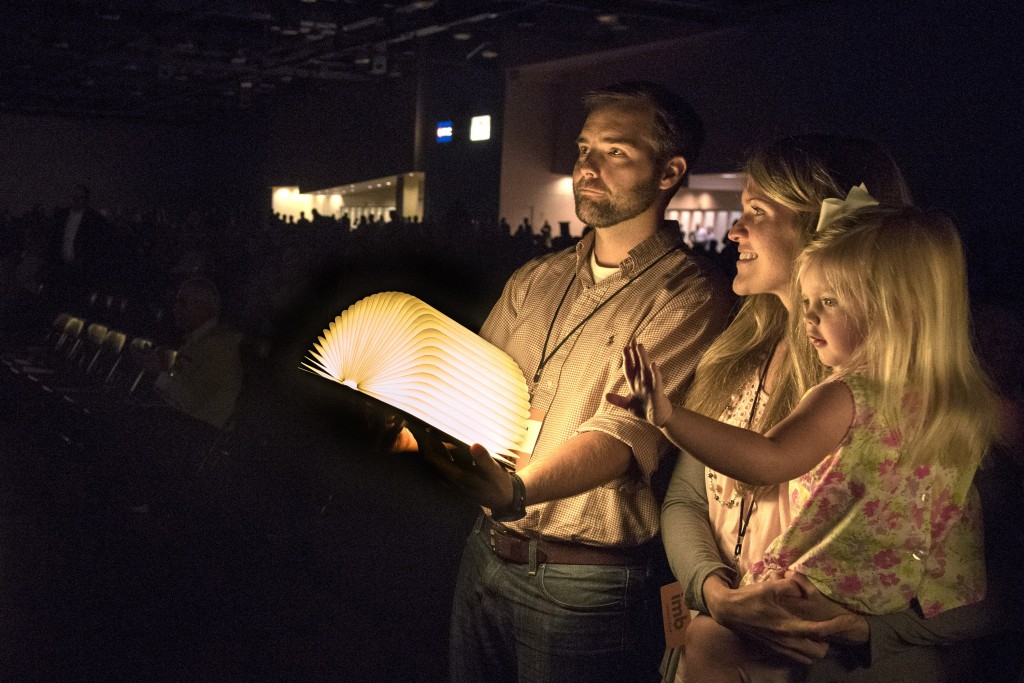 David and Katie Kizziah and their daughter Karis, hold a book that lights up when opened during the morning session June 17 at the Greater Columbus Convention Center in Columbus, Ohio. At the end of the Church and Mission Sending Celebration by the International Mission Board and the North American Mission Board, each missionary stood up and opened their book. Photo by Paul W. Lee/IMB