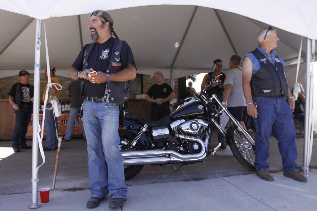 Baptist volunteers Roger Persing and Lyn Hanson work to draw passersby into a hospitality tent at the Sturgis Motorcycle Rally in 2010 where they heard testimony of God's power to change people. BP file photo