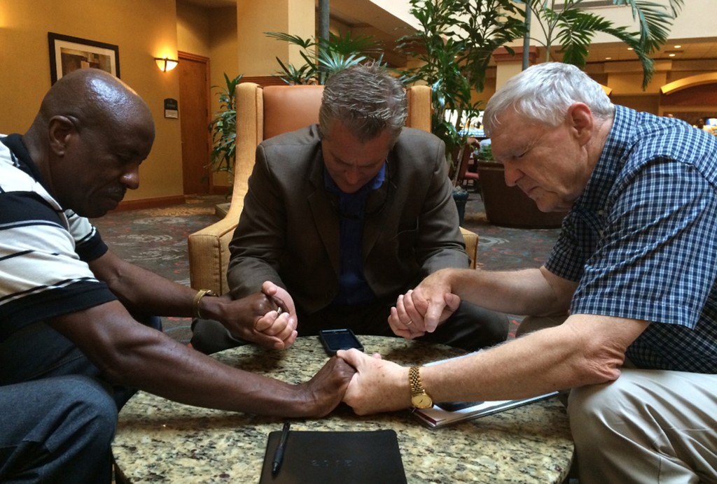 Powdersville First Baptist Church Pastor Brad Atkins, center, prays with fellow pastors after the June shooting at Emmanuel AME Church in Charleston, S.C., where nine worshippers were killed. With him are Summerville, S.C. pastor Edward Johnson, left, and Charleston pastor Frank Seigneous. Submitted photo